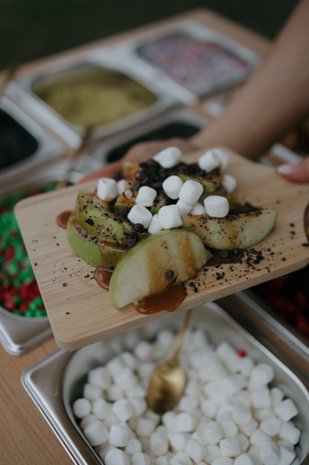 Apple slices topped with mini marshmallows, cookie crumble, and mini chocolate chips