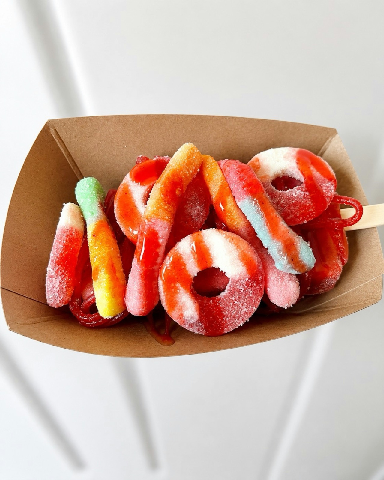 A serving of sour candy rings and worms from the topping bar